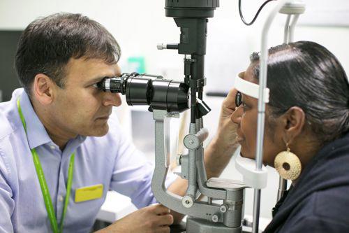 Consultant examining patient using technical equipment