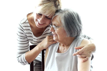 Older person cuddling younger person