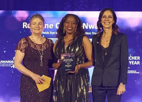 Prof Roxanne Crosby standing with two other people at the nursing awards
