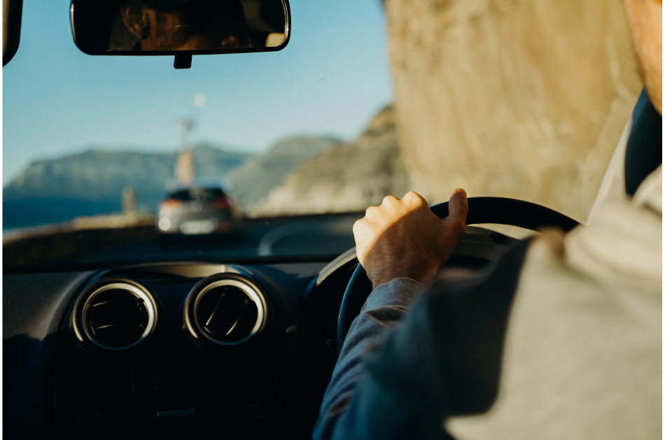 A person driving his car on a clear day