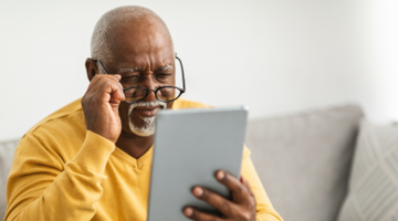 A senior man looking at the tablet