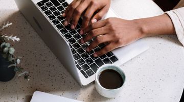 A person typing on a laptop