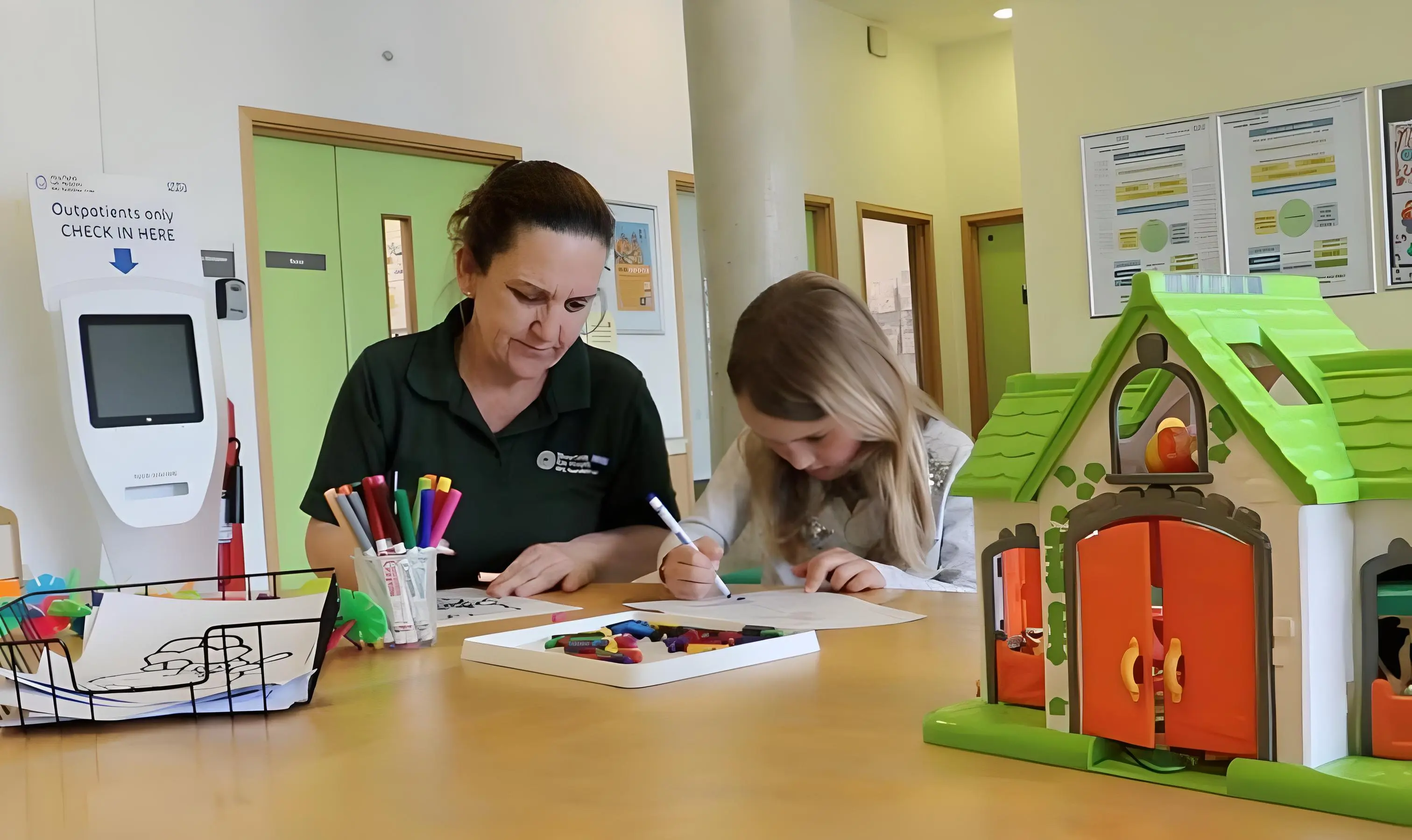  A health play specialist supporting a colouring activity