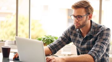 A young man working on the laptop